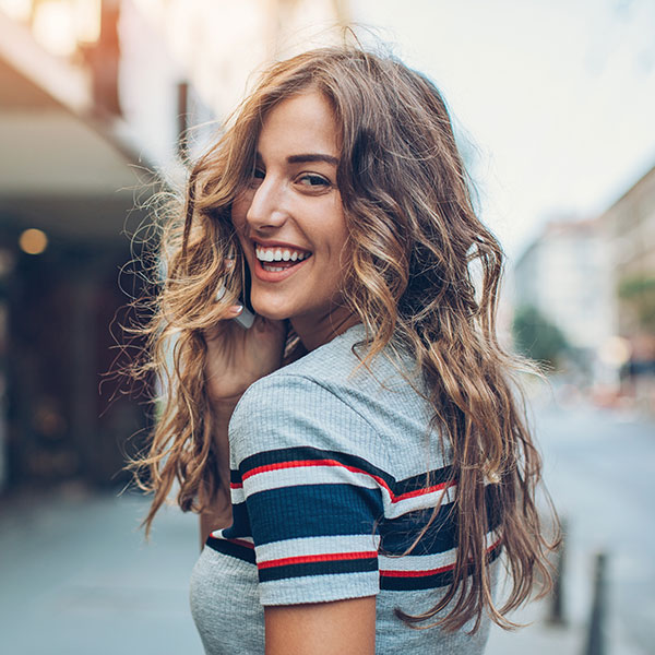 a smiling woman looking back at the camera